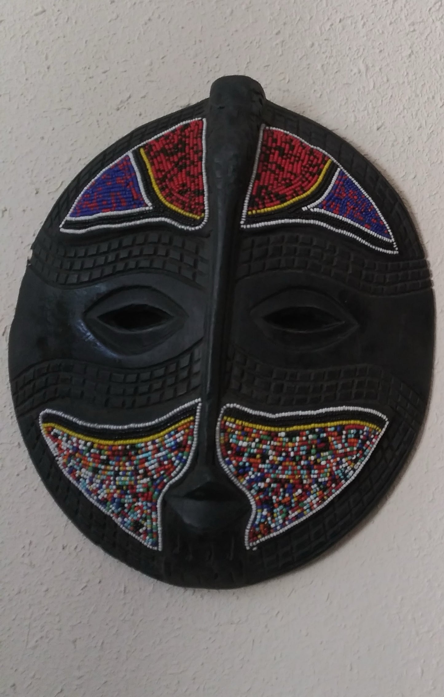 Round colorful wall mask.